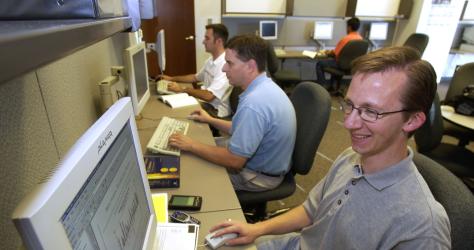 Three MBA students in a computer lab