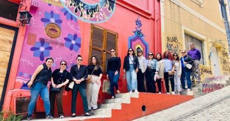 MBA students in Chile in front of a pink and orange mural