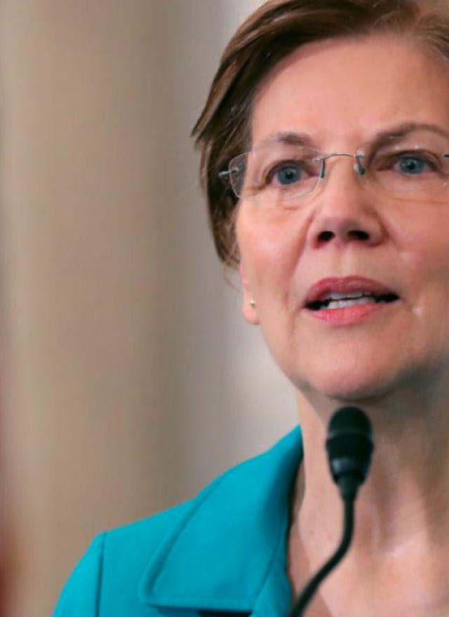 Elizabeth Warren speaking on a podium