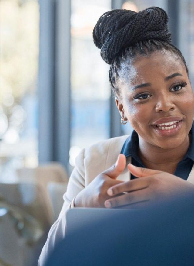 stock photo of a woman leading a work meeting