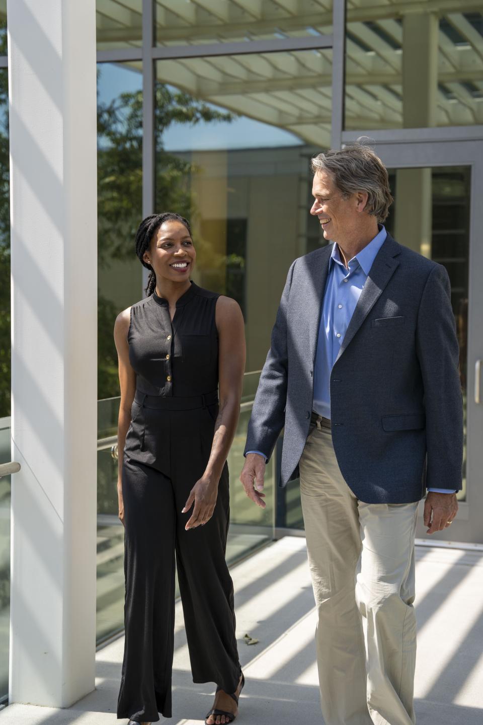 Cami Harris MBA 22 and Professor Andy Hargadon walking outside UC Davis' Gallagher Hall