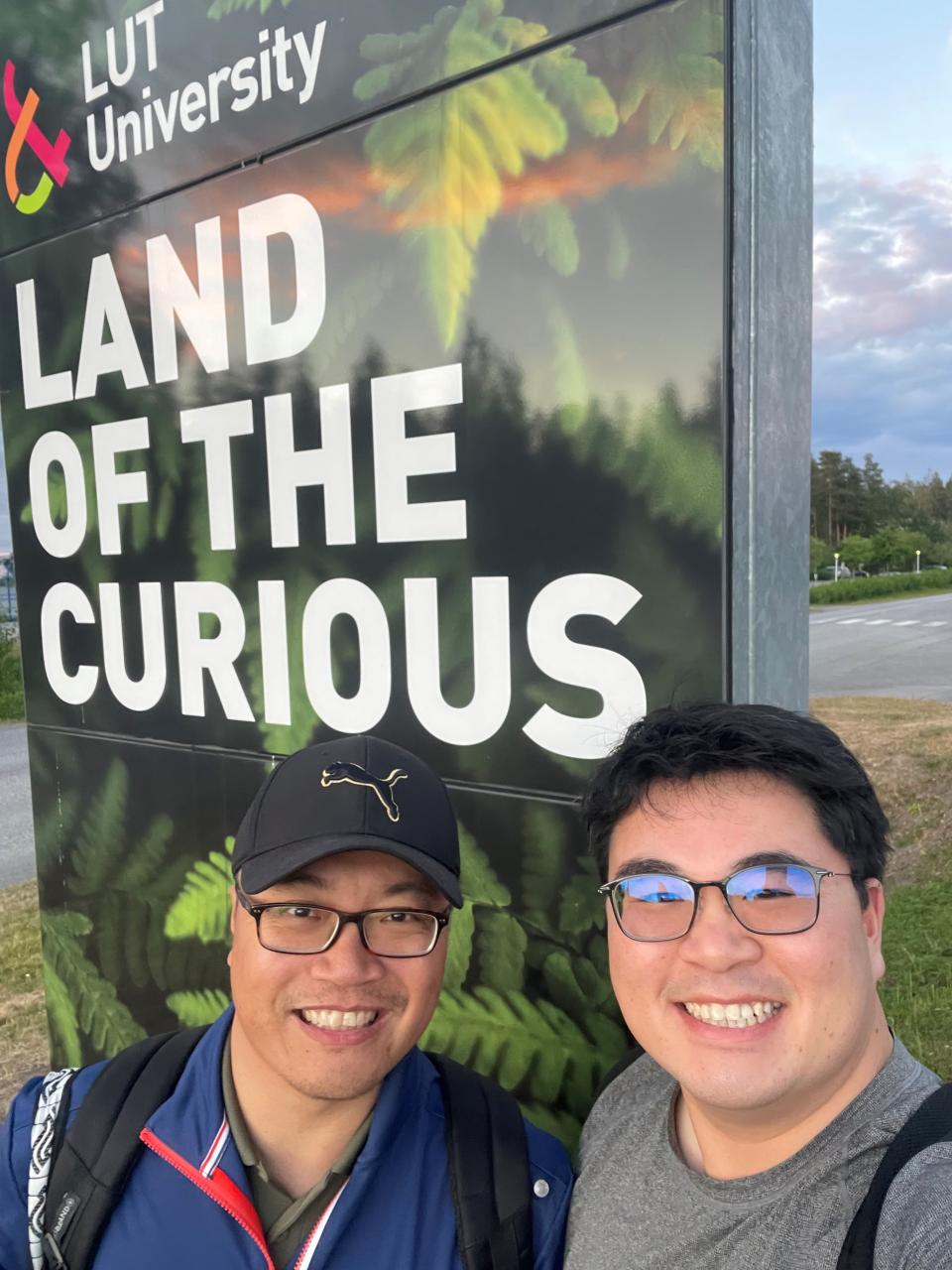 Two people standing in front of LUT University sign