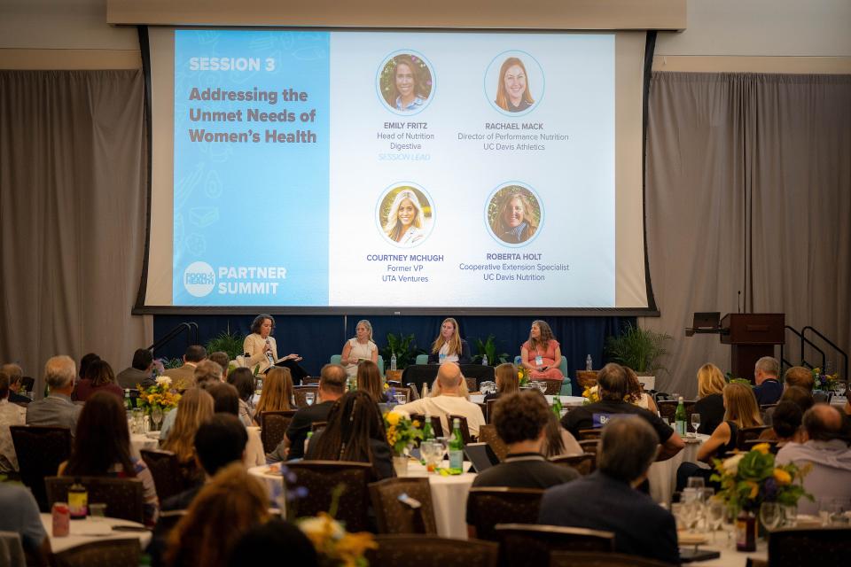 Panelists seated on stage at the UC Davis Food and Health Partner Summit session titled 'Addressing the Unmet Needs of Women’s Health.