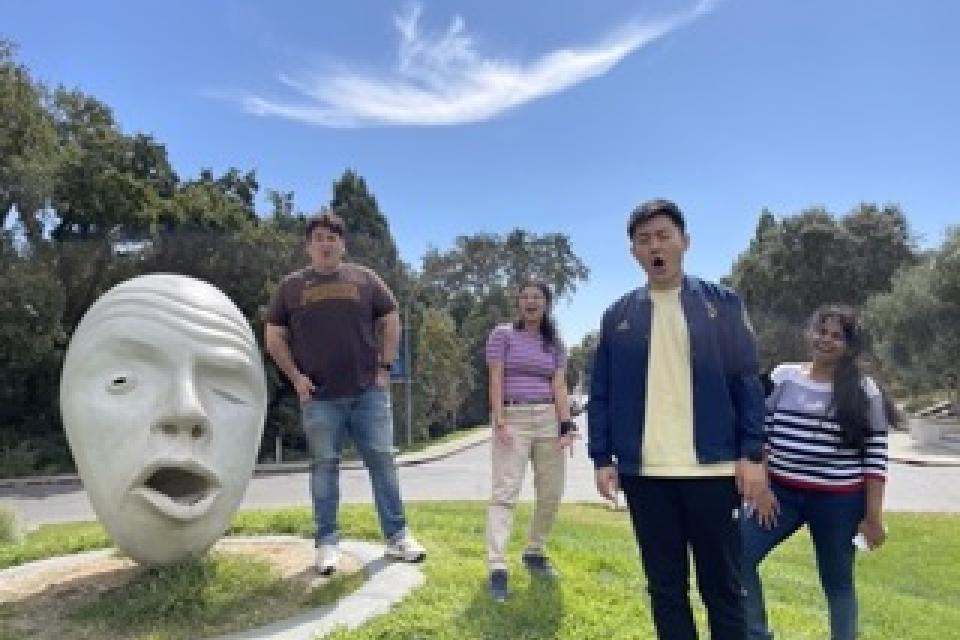 UC Davis students in front of Egghead sculpture