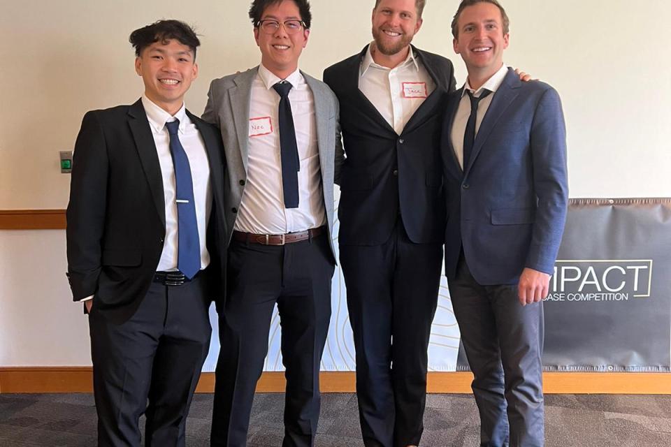 Minh Thieu Nguyen, Nic Seto, Jack Schaufler, Andrew Robert Collins dressed in professional attire at the Net Impact Case Competition