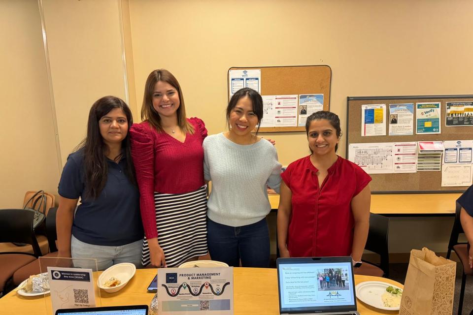 Anuja Gupta with three MBA students in a classroom